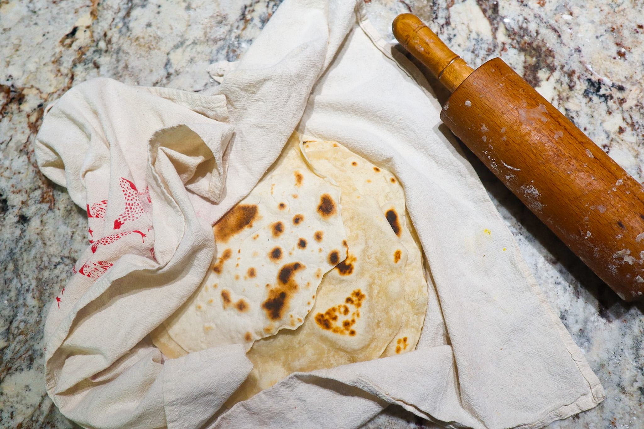 tortilla on counter with rolling pin