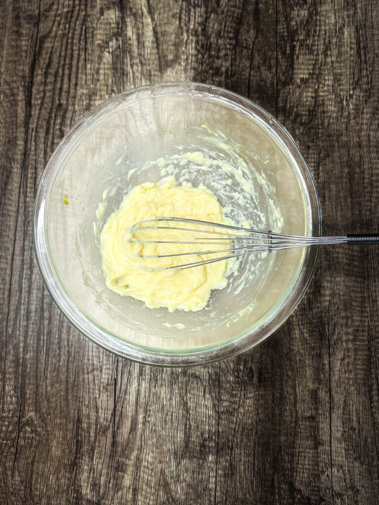 homemade mayo in a glass bowl on a counter top