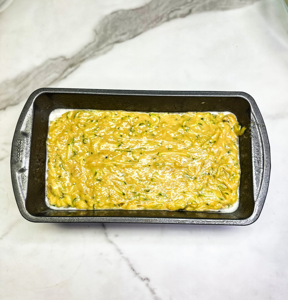 zucchini bread batter in a loaf pan